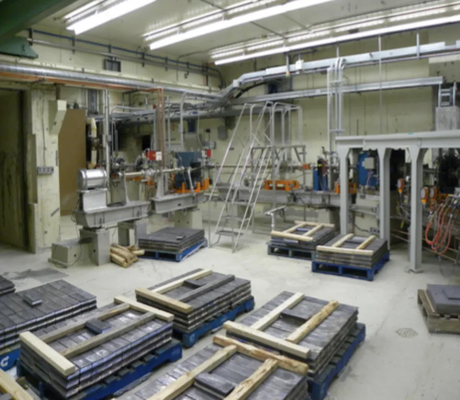 A radiation vault under construction, shielding blocks staged on the floor
